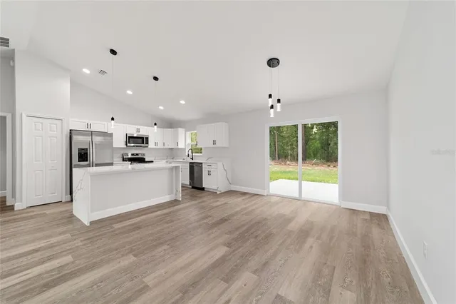 a view of kitchen with wooden floor and electronic appliances