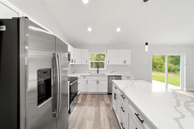 a kitchen with a sink stove and refrigerator
