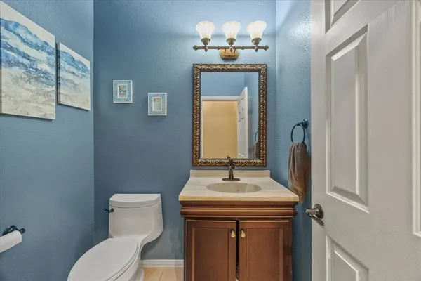 a bathroom with a sink a toilet and mirror