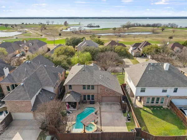 a view of a swimming pool with a patio and a yard