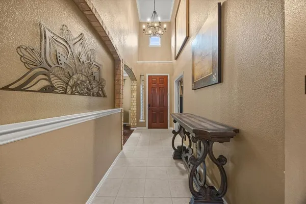 a view of a hallway with paintings on the wall