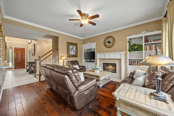 a living room with furniture a fireplace with wooden floor