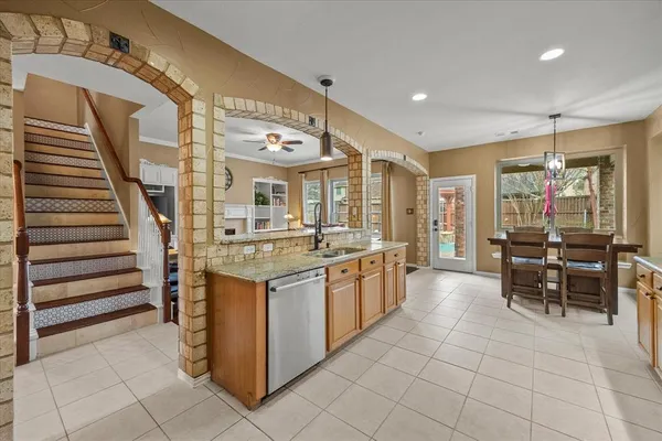 a kitchen with stainless steel appliances granite countertop lots of white cabinets a sink and dishwasher