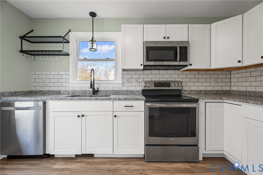 11101 Timonium Drive Chester, VA 23831 - Photo 11 of 21 a kitchen with granite countertop a stove and a sink