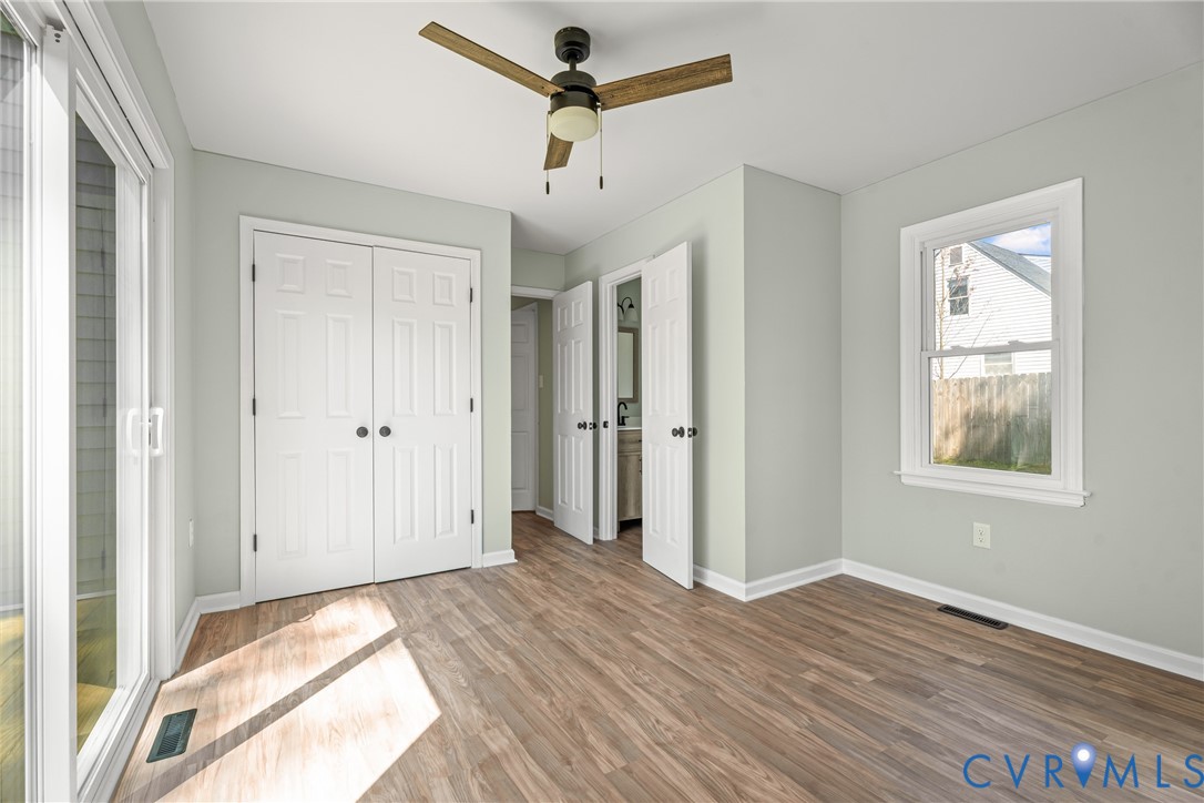 11101 Timonium Drive Chester, VA 23831 - Photo 14 of 21 a view of empty room with wooden floor and fan