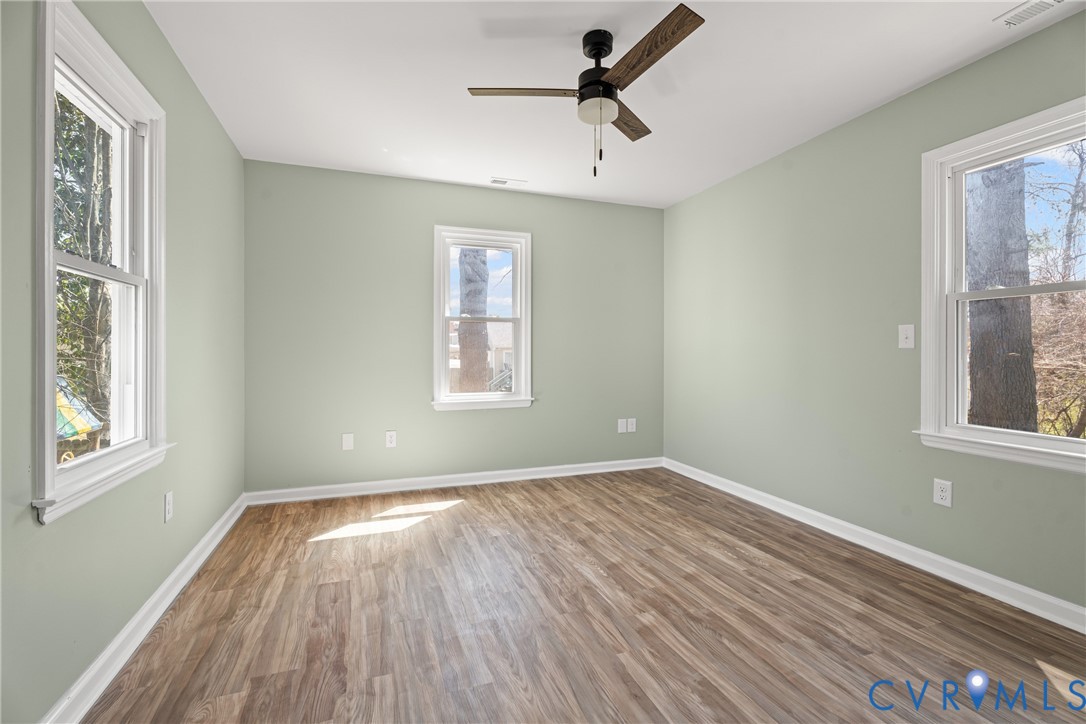11101 Timonium Drive Chester, VA 23831 - Photo 5 of 21 wooden floor in an empty room with a window