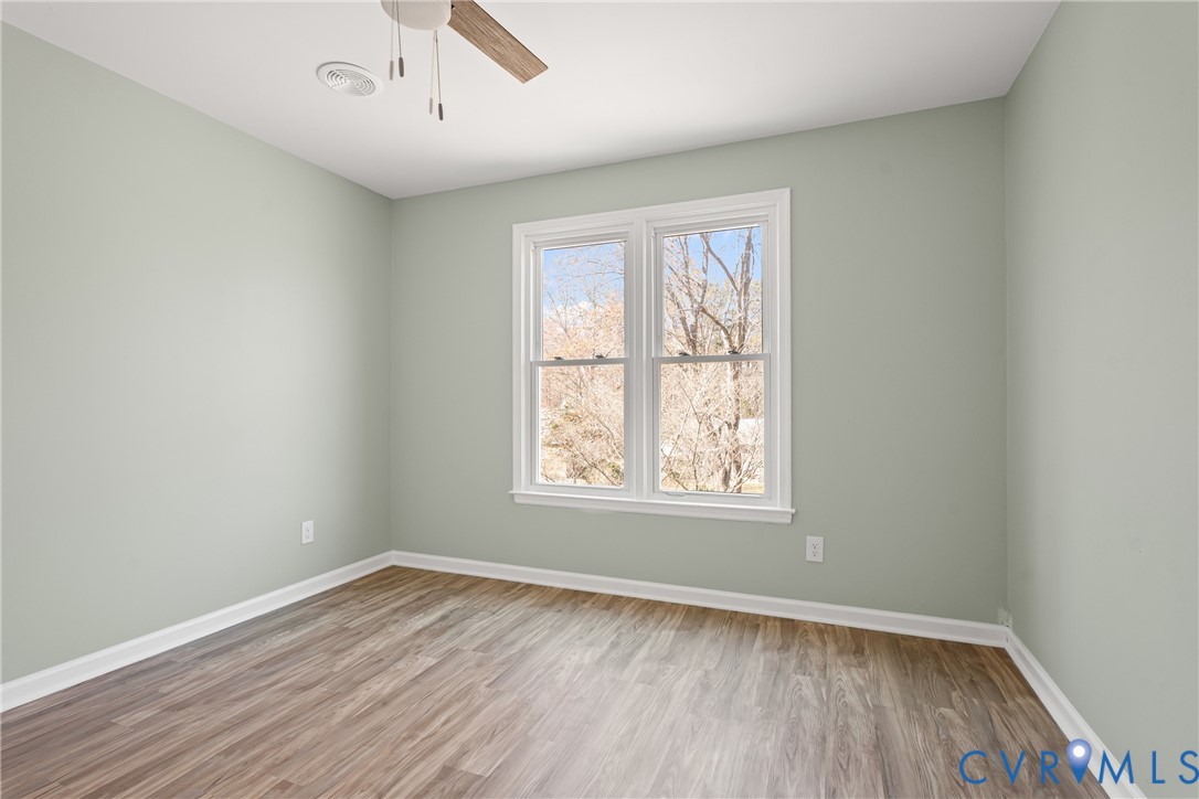 11101 Timonium Drive Chester, VA 23831 - Photo 6 of 21 an empty room with wooden floor and windows