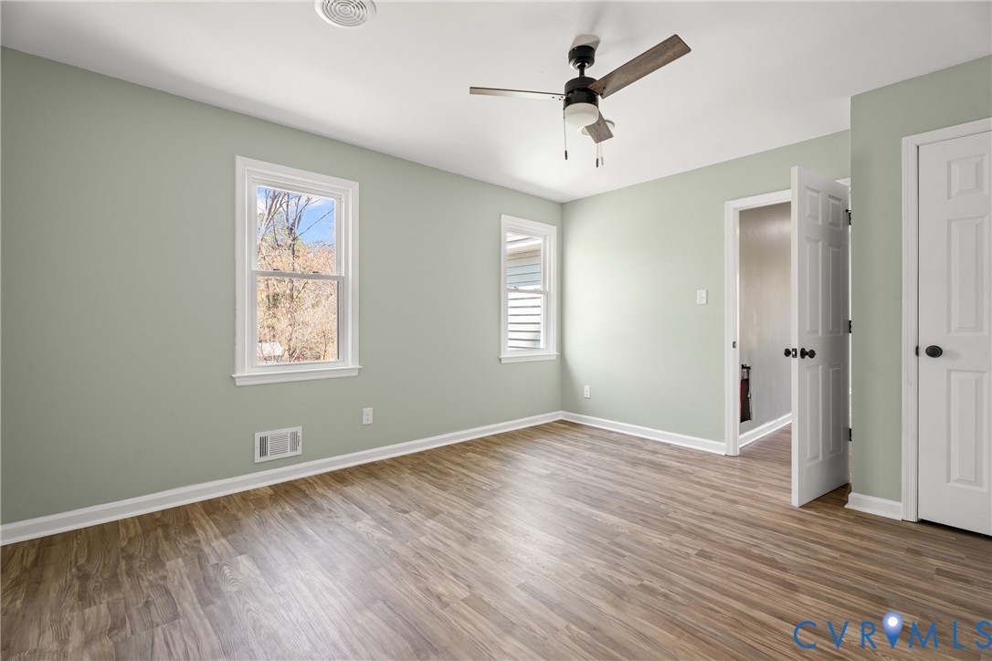 11101 Timonium Drive Chester, VA 23831 - Photo 7 of 21 an empty room with wooden floor and windows