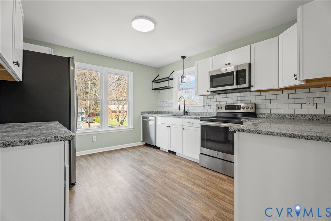 11101 Timonium Drive Chester, VA 23831 - Photo 10 of 21 a kitchen with stainless steel appliances white cabinets a sink and a stove
