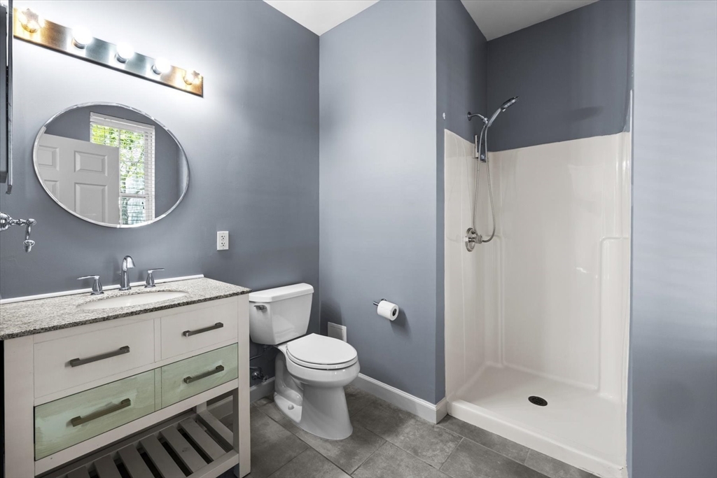 21 Hampshire Road, Unit 101 Methuen, MA 01844 - Photo 16 of 18 a bathroom with a toilet a sink and mirror
