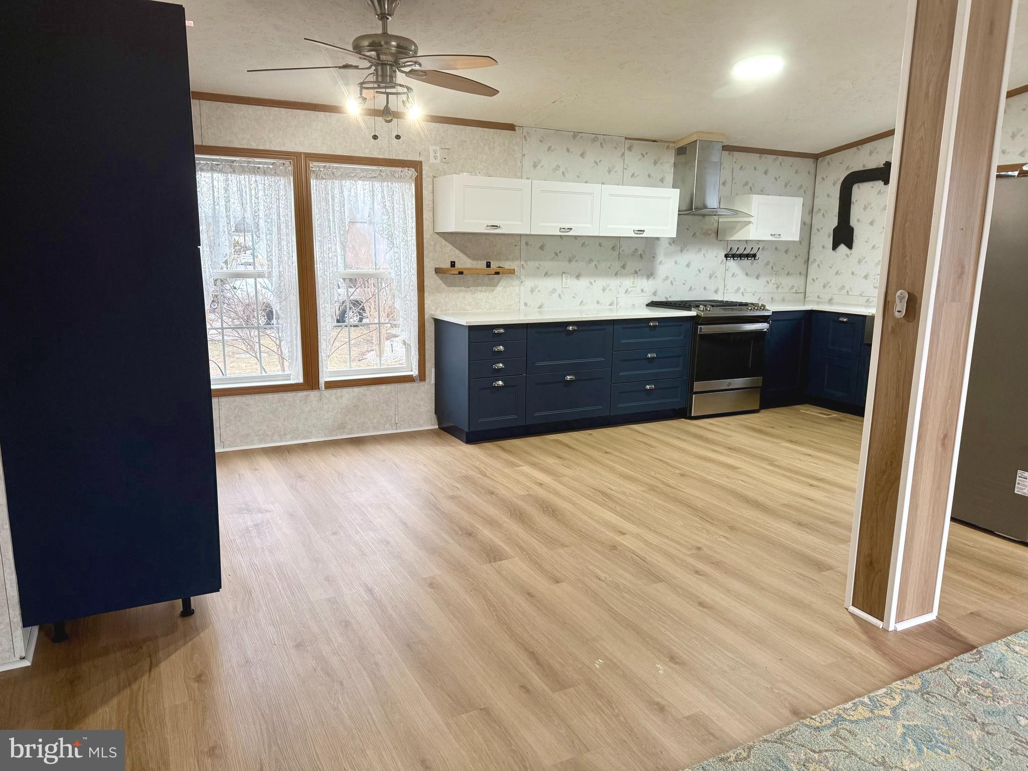92 Arrowhead Road Shamong, NJ 08088 - Photo 11 of 25 a kitchen with stainless steel appliances granite countertop a refrigerator a sink dishwasher a stove and white countertops with wooden floor