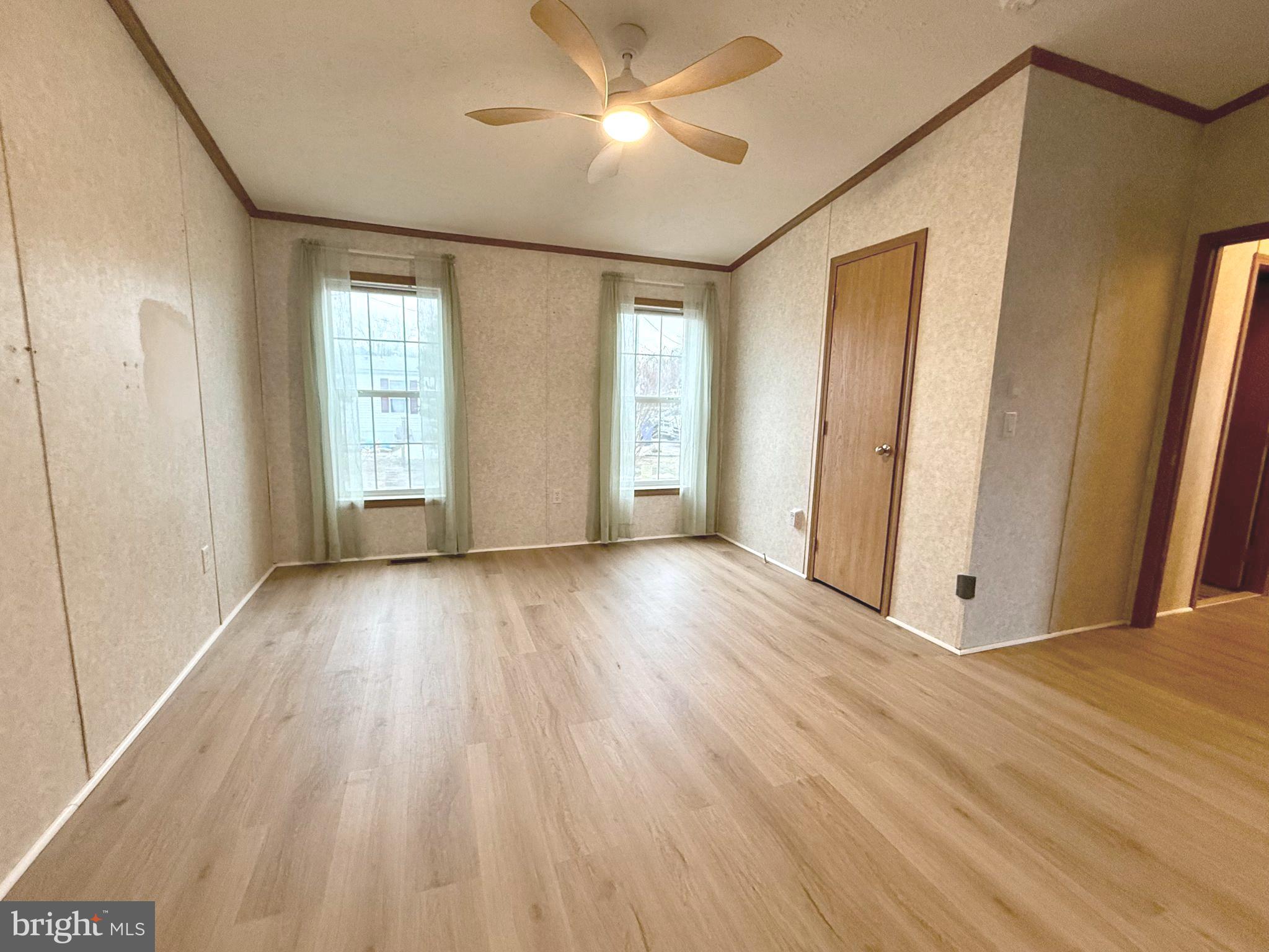 92 Arrowhead Road Shamong, NJ 08088 - Photo 19 of 25 a view of an empty room with a window and wooden floor