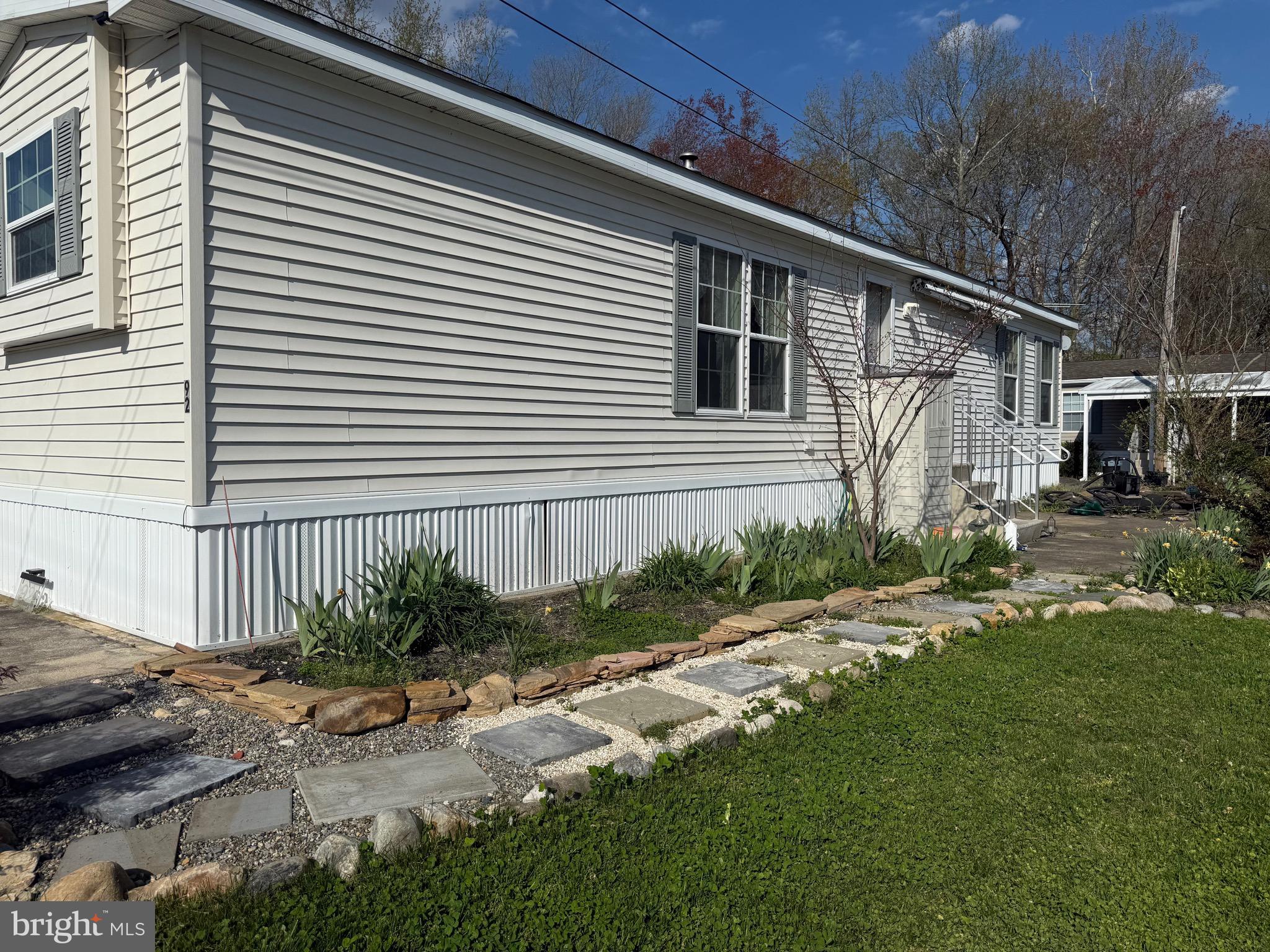 92 Arrowhead Road Shamong, NJ 08088 - Photo 7 of 25 a backyard of a house with garden and plants