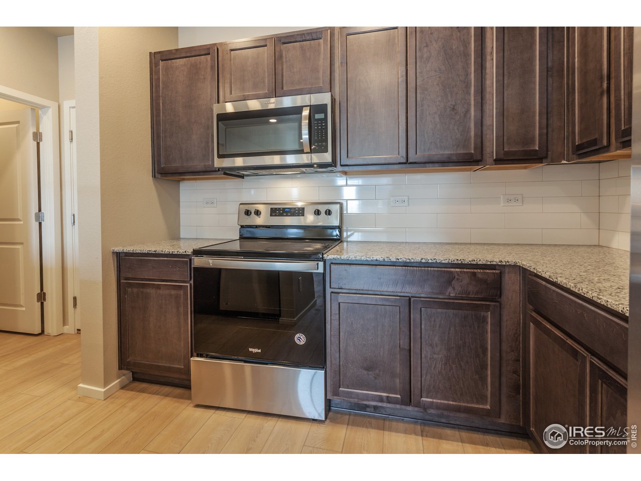 6613 4th St Road, Unit 4 Greeley, CO 80634 - Photo 12 of 34 EXAMPLE PHOTO: KITCHEN W/ S.S. DISHWASHER, FRIDGE, MICROWAVE, RANGE