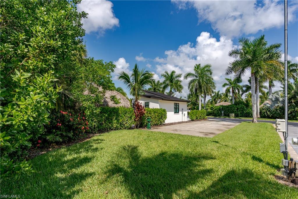 13499 Snook Circle Naples, FL 34114 - Photo 23 of 39 a front view of a house with garden