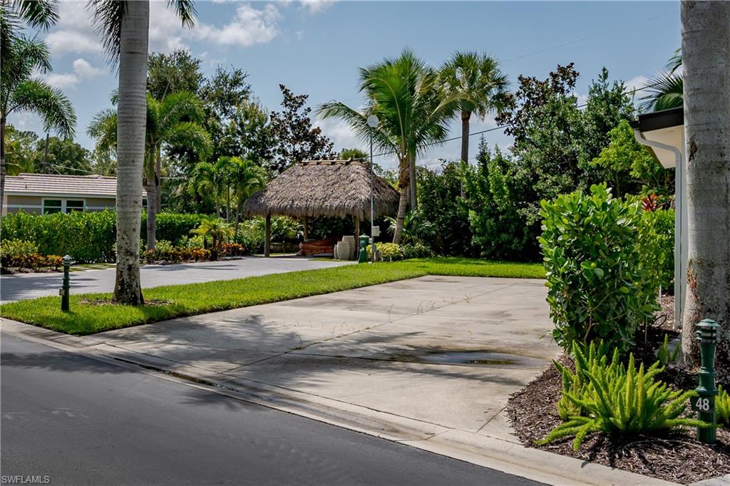 13499 Snook Circle Naples, FL 34114 - Photo 8 of 39 a view of a park with plants and palm trees