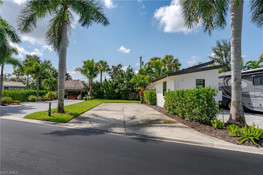 13499 Snook Circle Naples, FL 34114 - Photo 9 of 39 a house with palm tree in front of it