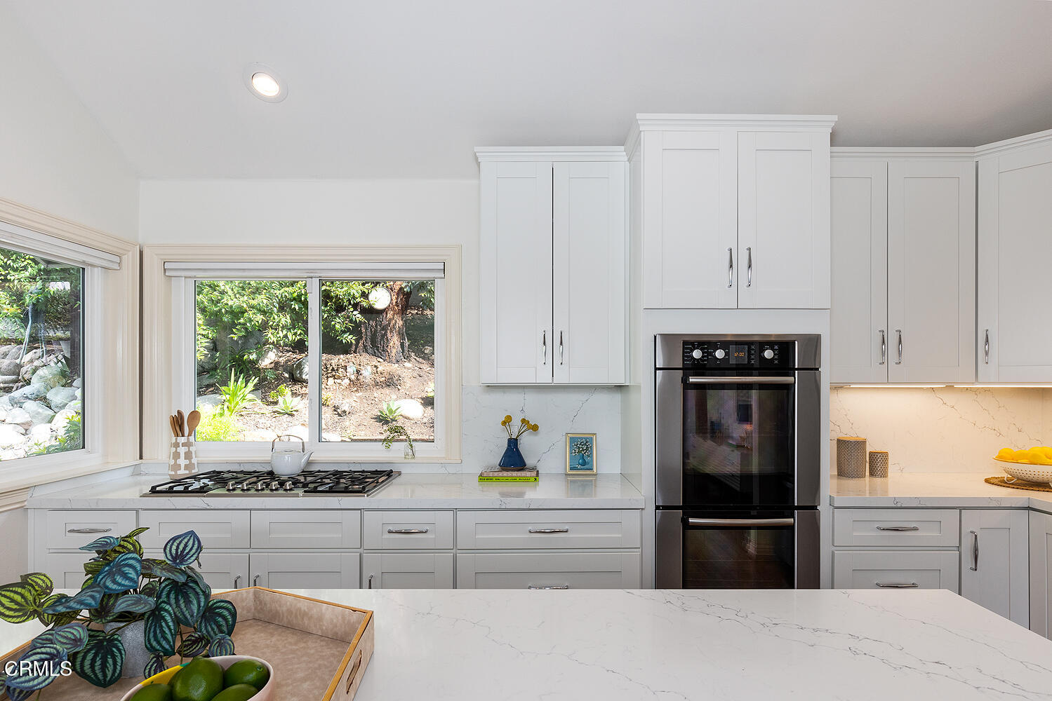 1386 Glen Oaks Boulevard Pasadena, CA 91105 - Photo 18 of 47 a kitchen with kitchen island granite countertop a refrigerator a stove a sink dishwasher and white cabinets with wooden floor
