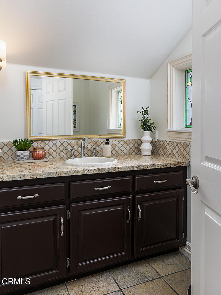1386 Glen Oaks Boulevard Pasadena, CA 91105 - Photo 24 of 47 a bathroom with a granite countertop sink and a mirror