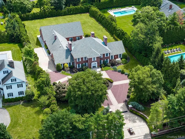 an aerial view of a house with swimming pool and garden