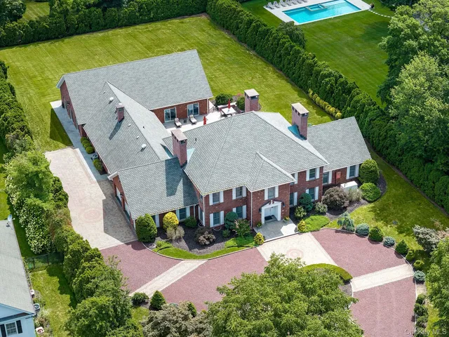 an aerial view of a house with a yard and lake view