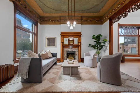 a living room with furniture large window and flat screen tv