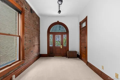 a view of an entryway door with a hallway