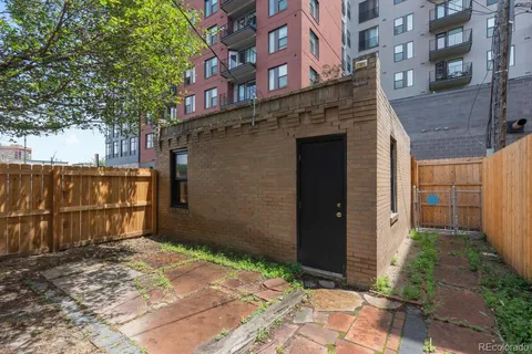 a brick building with a large tree
