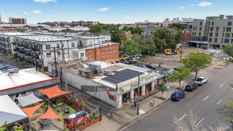 an aerial view of a building with cars parked