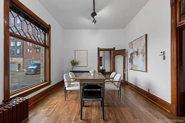 a view of a dining room with furniture and wooden floor