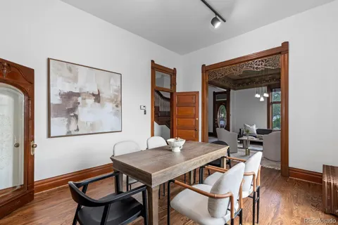 a view of a dining room with furniture and wooden floor