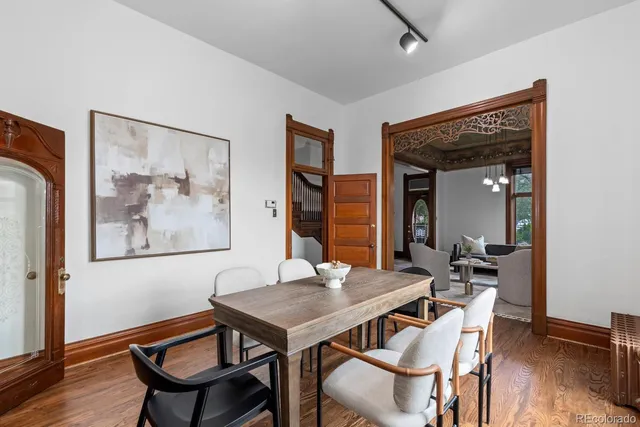 a view of a dining room with furniture and wooden floor