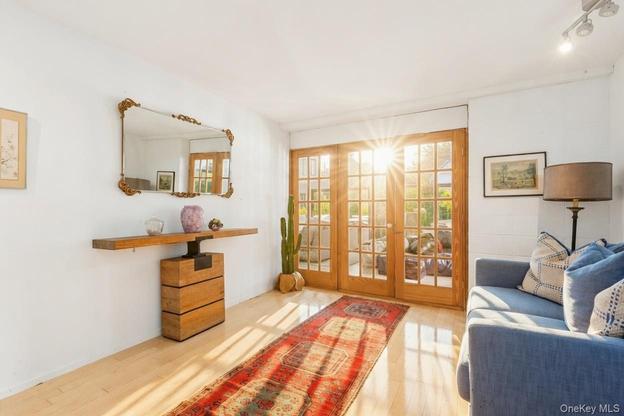 29 Huntting Road East Hampton, NY 11937 - Photo 11 of 29 a spacious bedroom with a bed and glass window