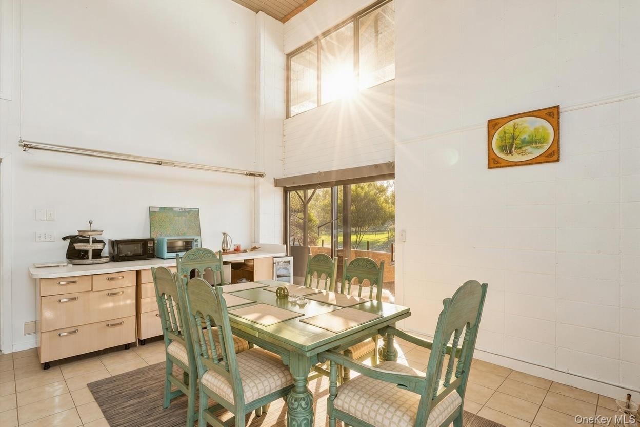 29 Huntting Road East Hampton, NY 11937 - Photo 14 of 29 a view of a dining room with furniture and a window