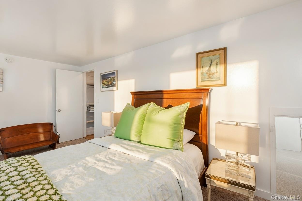 29 Huntting Road East Hampton, NY 11937 - Photo 19 of 29 a bedroom with a bed and a lamp with the dresser