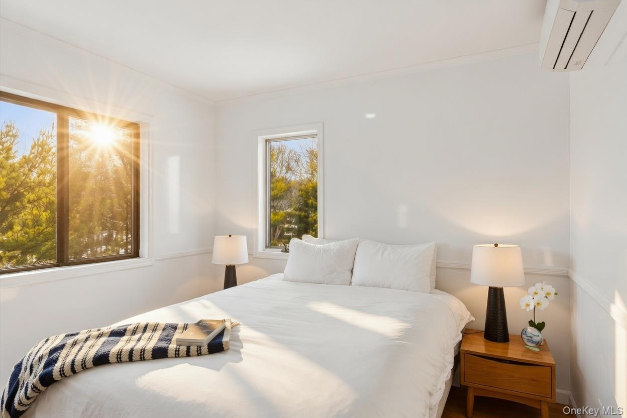 29 Huntting Road East Hampton, NY 11937 - Photo 25 of 29 a bedroom with a bed and wooden floor