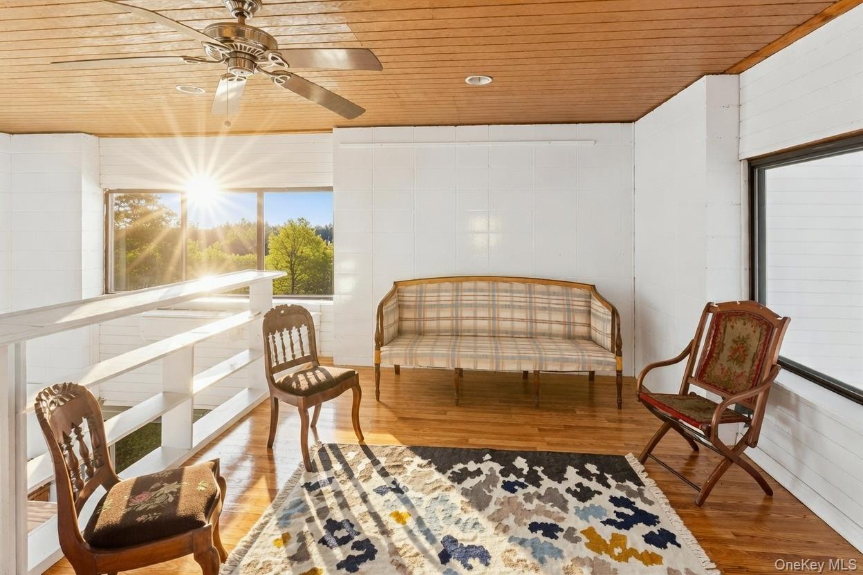 29 Huntting Road East Hampton, NY 11937 - Photo 26 of 29 a view of a chairs and table in the back yard of a building