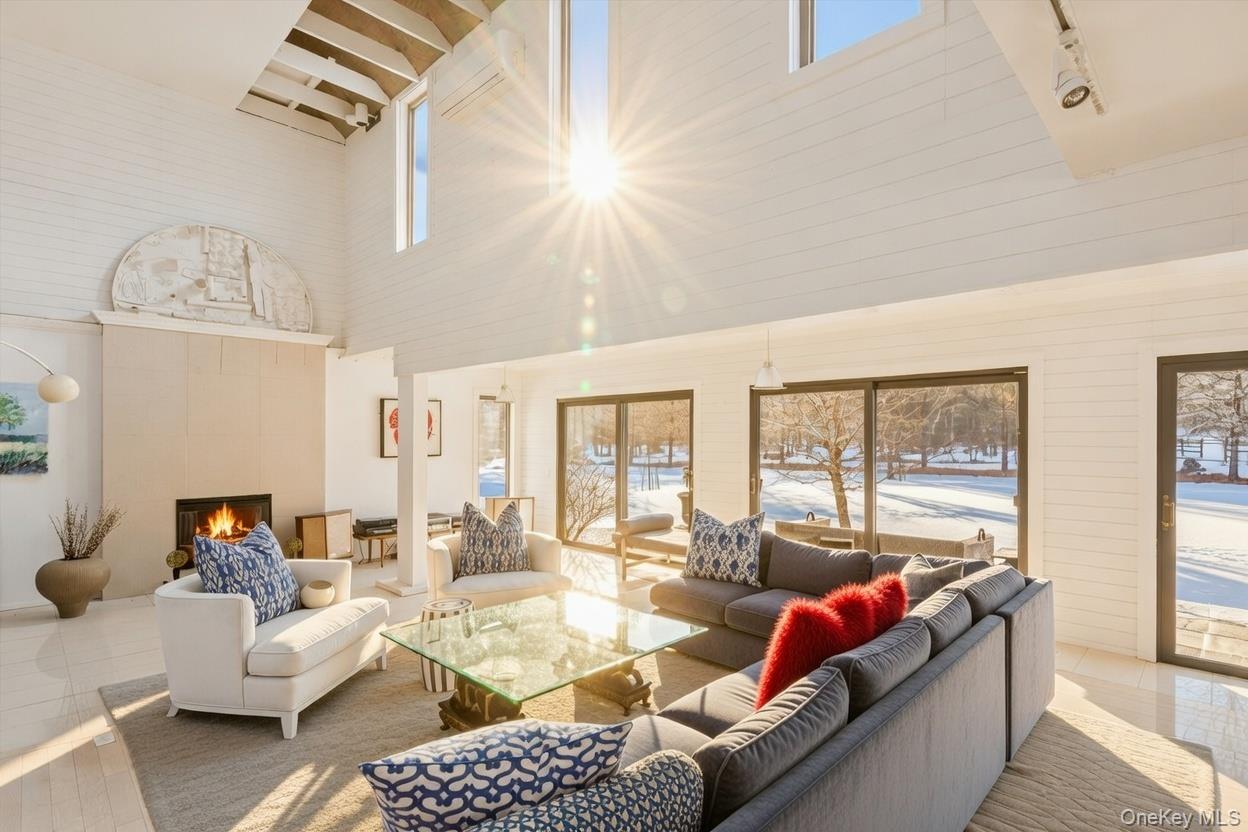 29 Huntting Road East Hampton, NY 11937 - Photo 9 of 29 a living room with furniture fireplace and a large window