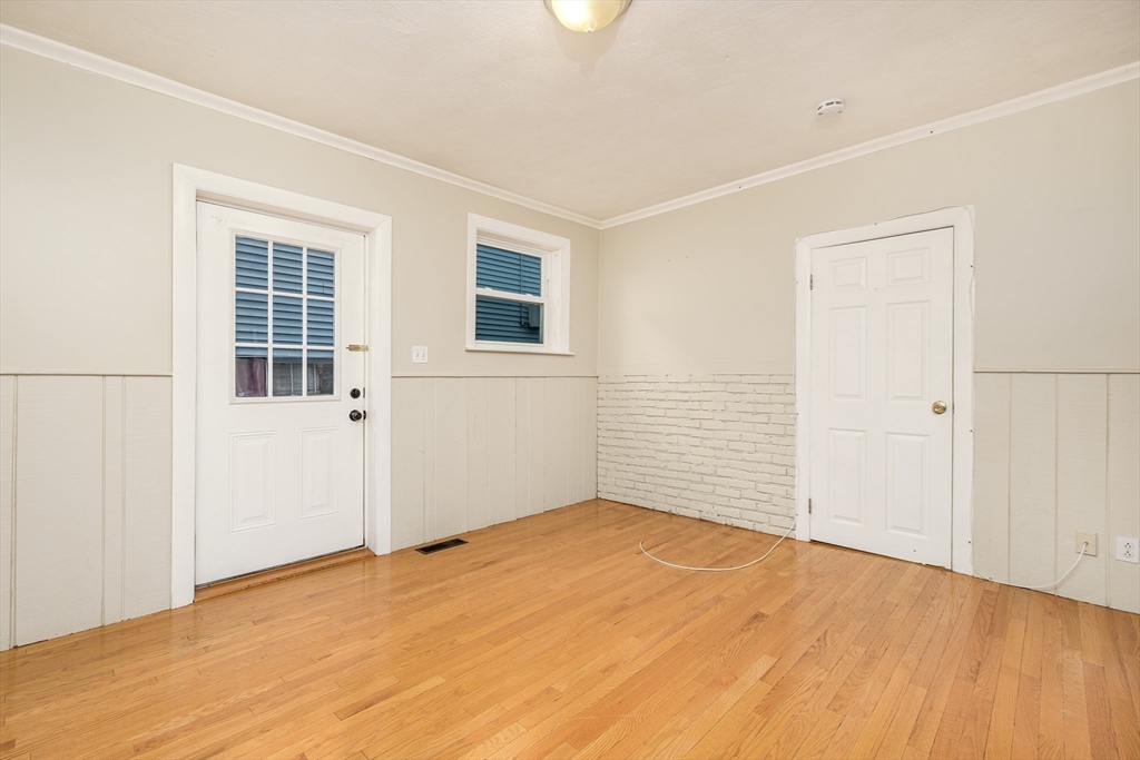 20 Hatch Street Everett, MA 02149 - Photo 6 of 16 a view of empty room with wooden floor and fan