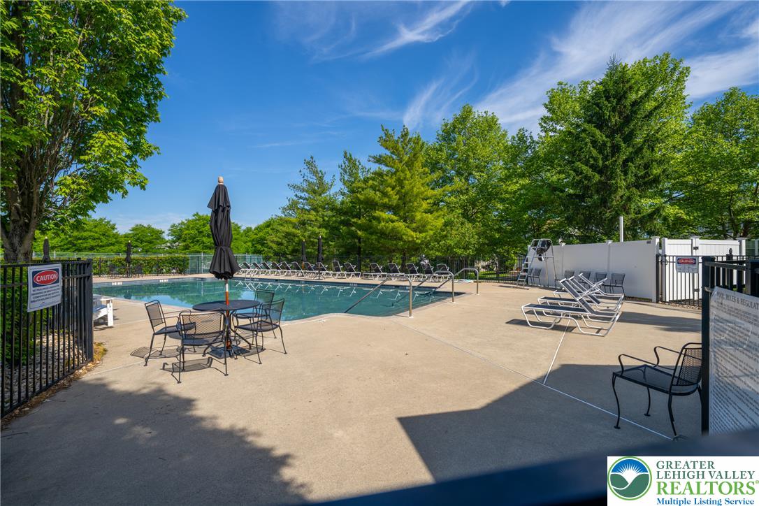 4345 Creek Road Allentown, PA 18104 - Photo 32 of 33 A fenced, inground community pool invites relaxation with ample lounging space and surrounding mature trees.