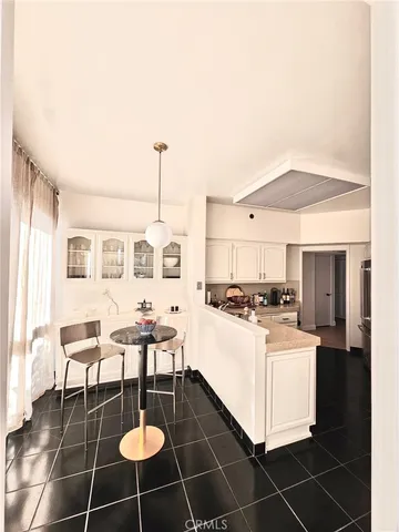 a living room with couches and pool table with wooden floor