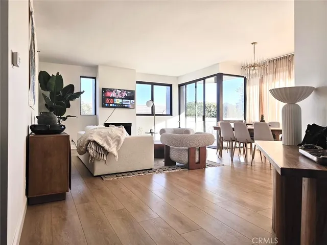 a living room with furniture large windows and a flat screen tv