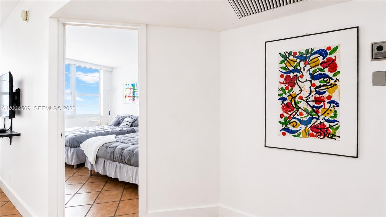 100 Lincoln Road, Unit 1209 Miami Beach, FL 33139 - Photo 9 of 25 a bed room with furniture and a painting
