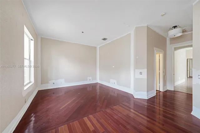 wooden floor in an empty room with a window