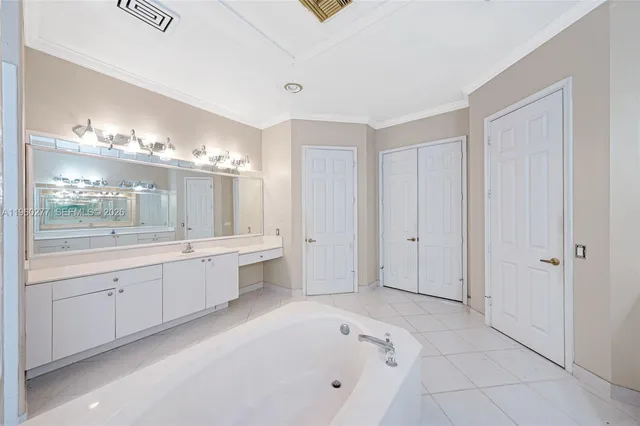 a large bathroom with a double vanity sink and a mirror