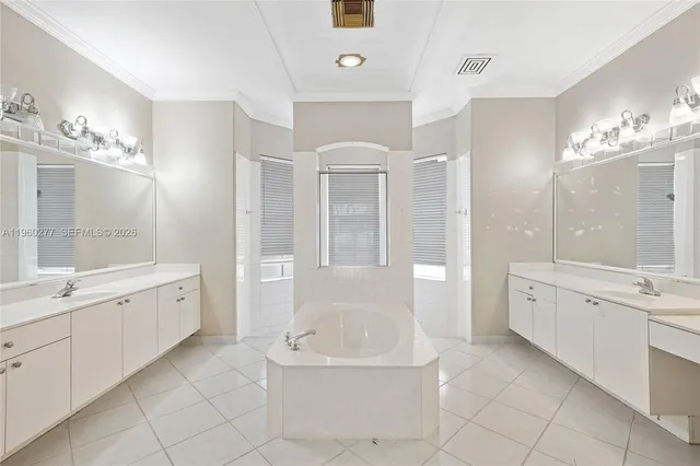 a spacious bathroom with a granite countertop sink a toilet a mirror and bathtub