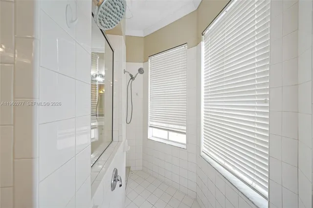 a bathroom with a bathtub and shower