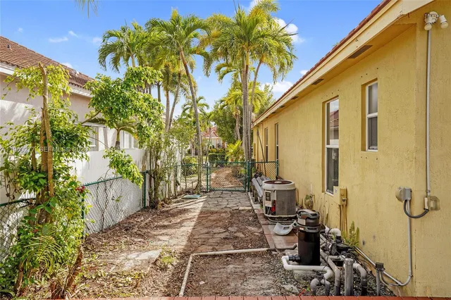 a pathway of a house with a yard