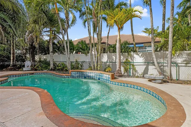 a swimming pool with outdoor seating and yard