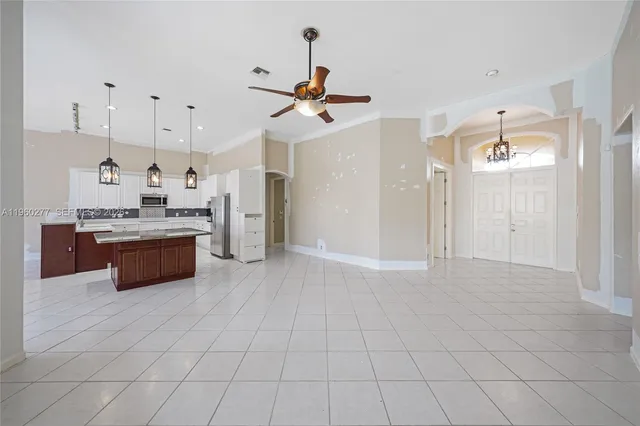 a large kitchen with cabinets and stainless steel appliances